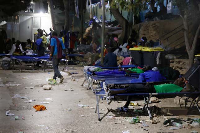 Migrants sleep outside on Lampedusa Island, Italy, Thursday, Sept. 14, 2023. A migrant reception center in Italy’s southernmost island of Lampedusa was overwhelmed Thursday as authorities worked to transfer to the mainland thousands of people who arrived on small, unseaworthy boats in a 24-hour span this week. (Cecilia Fabiano/LaPresse via AP)