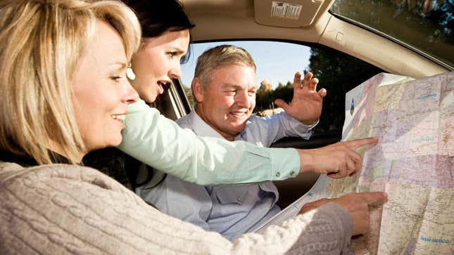 Mom, dad, and their daughter have fun quarreling over which directions to take.