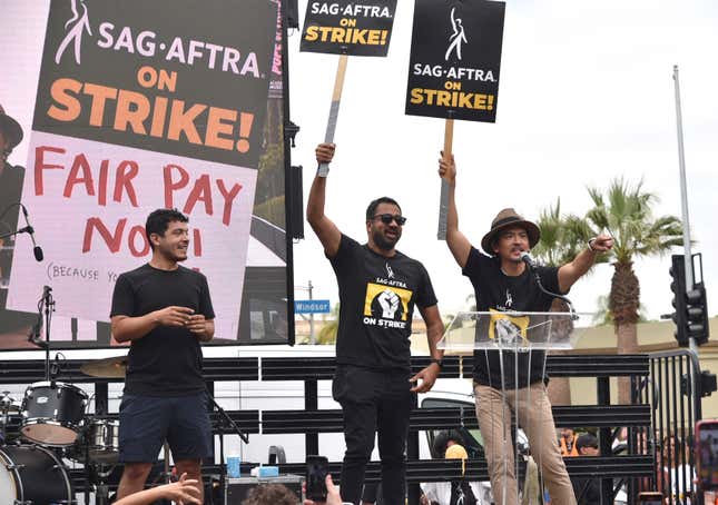 Kal Penn, center, and John Cho, right, speak during a rally outside Paramount Pictures Studio on Wednesday, Sept. 13, 2023, in Los Angeles. The film and television industries remain paralyzed by Hollywood&#39;s dual actors and screenwriters strikes. (Photo by Richard Shotwell/Invision/AP)