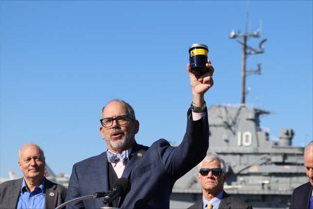 South Carolina Department of Natural Resources Director Robert Boyles holds a jar of toxic waste outside the USS Yorktown at a press conference in Mount Pleasant, S.C., on Tuesday, March 19, 2024. Officials are preparing to remove over 1.2 million gallons of hazardous liquids from the World War II-era aircraft carrier. (AP Photo/James Pollard)