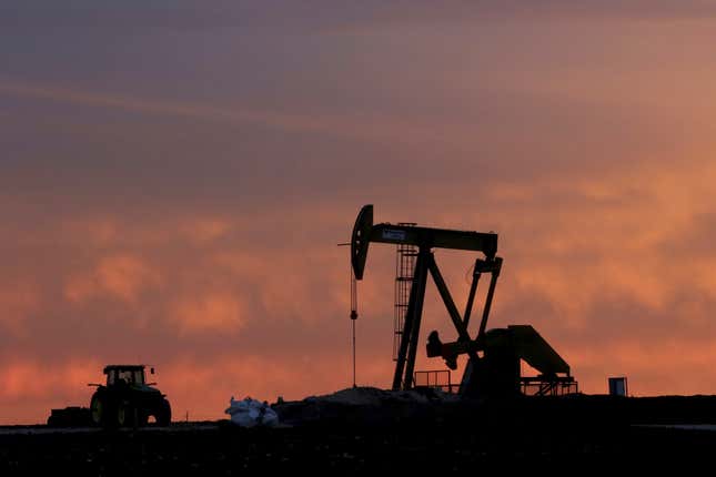 FILE - A well pump works at sunset on a farm near Sweetwater, Texas, on Dec. 22, 2014. Diamondback Energy will buy rival Endeavor Energy Resources in a cash-and-stock deal valued at about $26 billion to create a drilling giant in the Southwest United States. (AP Photo/LM Otero, File)