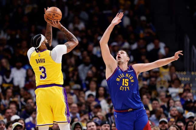 Oct 24, 2023; Denver, Colorado, USA; Los Angeles Lakers forward Anthony Davis (3) attempts a shot as Denver Nuggets center Nikola Jokic (15) guards in the second quarter at Ball Arena.