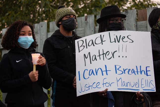 People listen during a vigil for Manuel Ellis, a Black man whose March death while in Tacoma Police custody was recently found to be a homicide, according to the Pierce County Medical Examiner’s Office, near the site of his death on June 3, 2020 in Tacoma, Washington. 