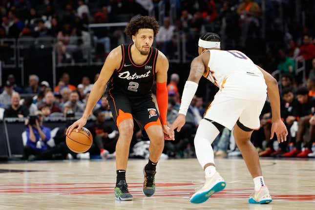 Nov 5, 2023; Detroit, Michigan, USA;  Detroit Pistons guard Cade Cunningham (2) dribbles defended by Phoenix Suns guard Jordan Goodwin (0) at Little Caesars Arena.