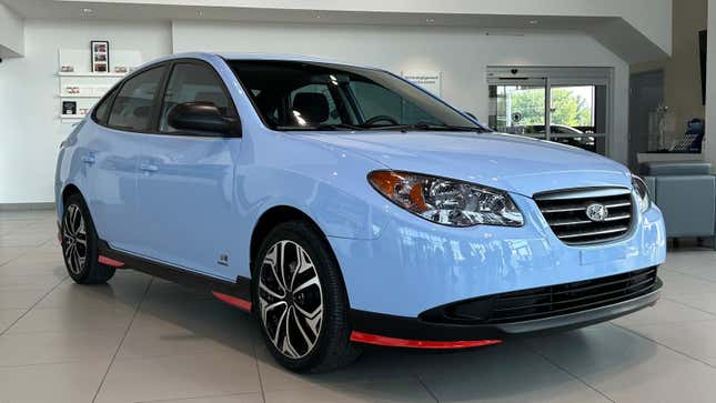 A front 3/4 shot of the performance blue Elantra parked in a showroom