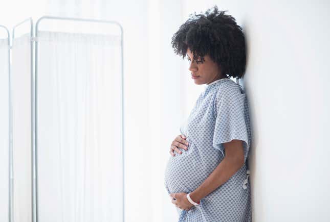 Black Woman holding Stomach 