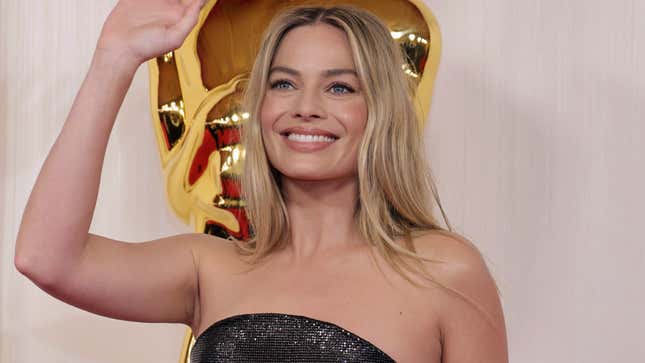 Margot Robbie waves while attending the 96th Academy Awards on March 10 in Hollywood, California.