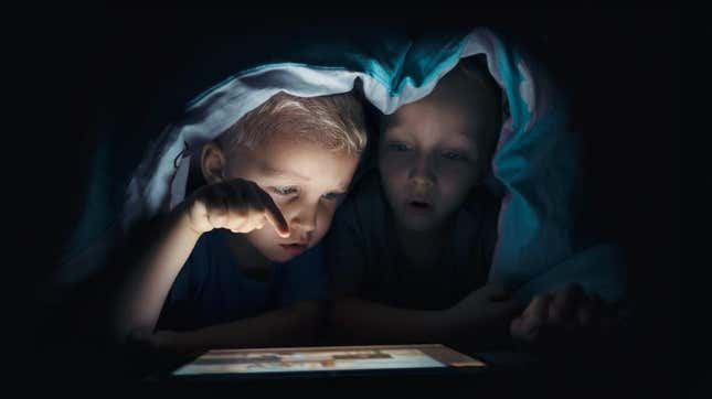 Kids using an iPad in the dark