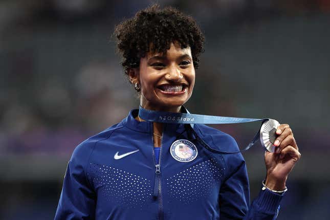 Anna Cockrell celebrates on the podium during the victory ceremony for the women’s 400m hurdles athletics event during the Paris 2024 Olympic Games at Stade de France in Saint-Denis, north of Paris, on August 9, 2024.