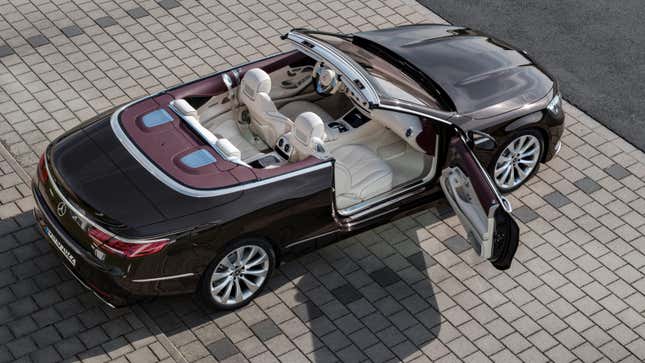 A Mercedes S Class Cabriolet parked with the top down and the passenger door open showing the beautiful interior