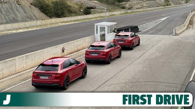 Three red 2025 Audi RS Q8 Performance SUVs about to go on a race track