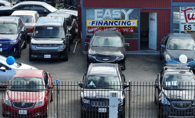 An advertisement of easy financing is posted on the front window of a used car lot on September 06, 2023 in San Pablo, California