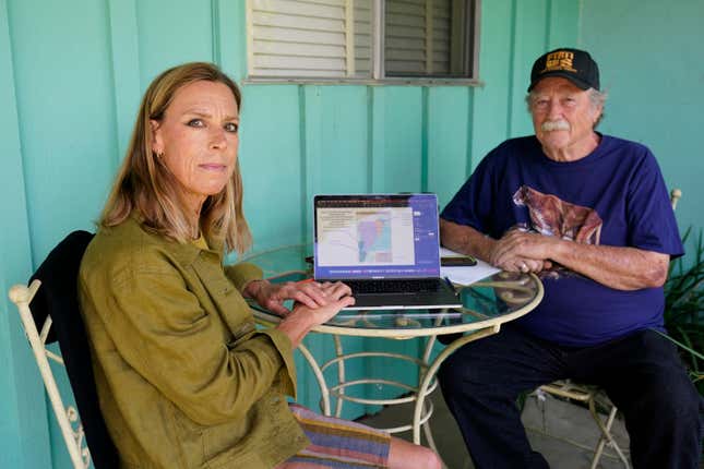 Amanda Frye, left, and Steve Loe, a retired U.S. Forest Service biologist, pose for a portrait on Friday, Sept. 15, 2023, in Redlands, Calif. The two have led efforts to stop BlueTriton, the company that produces the widely-known Arrowhead brand of bottled water, from drawing water from certain points in the San Bernardino National Forest. The State Water Resources Control Board is expected to vote Tuesday on whether to issue a cease-and-desist order against BlueTriton. (AP Photo/Ashley Landis)