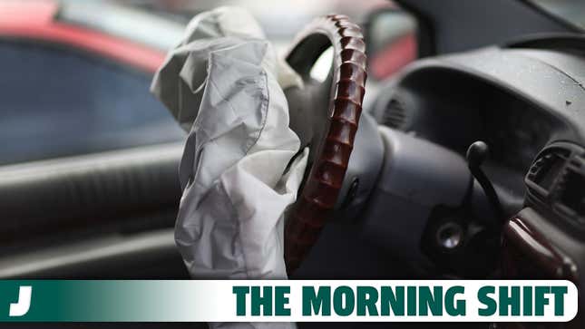 A photo of an airbag coming out the steering wheel of a car. 