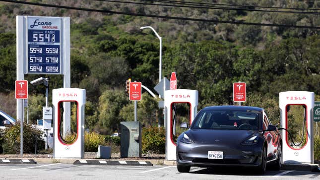 A Tesla car recharges its battery at a Supercharger on March 10, 2022 in San Bruno, California.