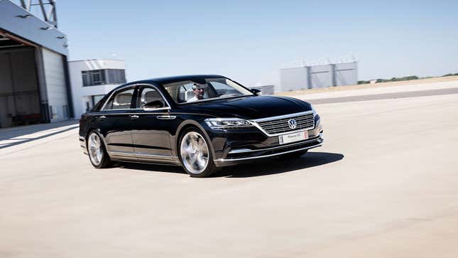 A photo of a black VW Phaeton D2 concept car driving in an airport. 