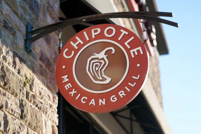 FILE - The Chipotle Mexican Grill logo hangs outside a restaurant location, Dec. 20, 2022. On Wednesday, Sept. 27, 2023, a federal agency sued the restaurant chain Chipotle, accusing it of religious harassment and retaliation after a manager at a Kansas location forcibly removed an employee&#39;s hijab, a headscarf worn by some Muslim women. (AP Photo/Steven Senne, File)