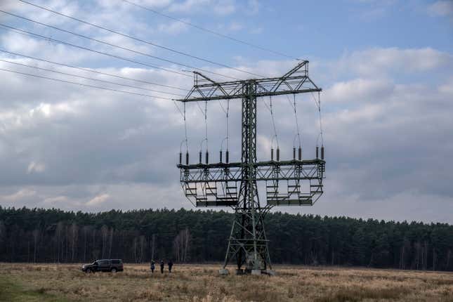 FILE - Police officers work next to a damaged pylon near the Tesla Gigafactory for electric cars in Gruenheide near Berlin, Germany, on March 5, 2024. Power has been restored to electric car manufacturer Tesla&#39;s factory near Berlin about a week after an outage believed to have been caused by arson, a network operator says. Grid operator E.DIS said in a statement that Tesla was reconnected to the network at 8:45 p.m. Monday, March 11, 2024, after days of repairs. (AP Photo/Ebrahim Noroozi)