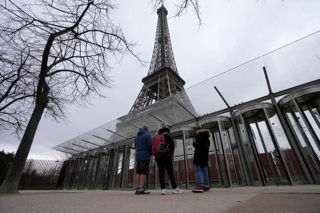 Visitors stand at the closed gates leading to the Eiffel Tower, Tuesday, Feb. 20, 2024 in Paris. Visitors to the Eiffel Tower were turned away for the second consecutive day because of a strike over poor financial management at one of the world&#39;s most-visited sites. (AP Photo/Michel Euler)