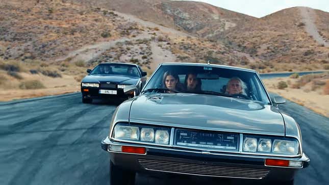 A screenshot from the "Joyride" music video of the Citroen SM and Aston Martin Lagonda on Willow Springs