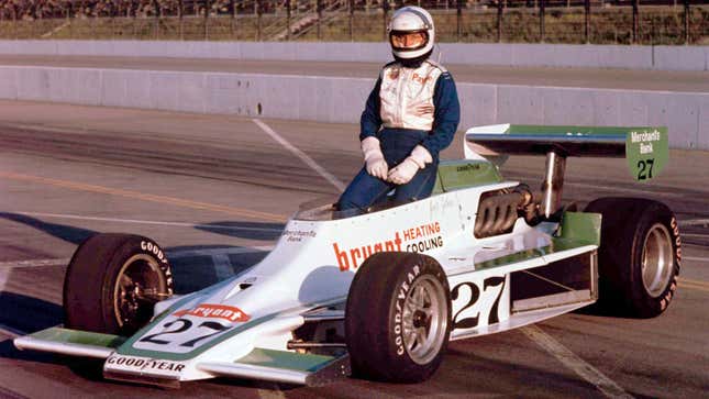 Janet Guthrie poses with an Indy car at Ontario Motor Speedway, 1977