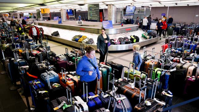 Travelers search for their suitcases in a baggage holding area for Southwest Airlines at Denver International Airport on December 28, 2022 in Denver, Colorado.