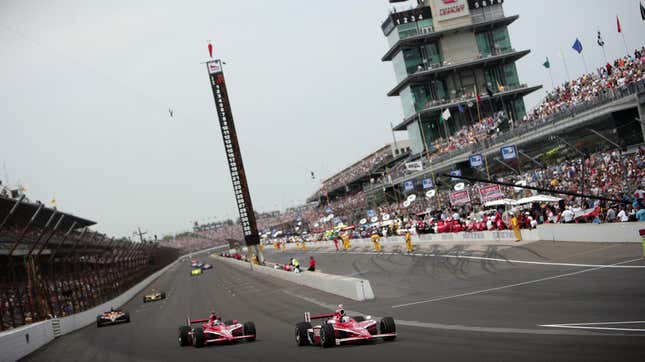 Scott Dixon, driver of the #9 Target Chip Ganassi Racing Dallara Honda, leads the pack with teammate Dan Wheldon, driver of the #10 Target Chip Ganassi Racing Dallara Honda, at the final re-start during the IRL IndyCar Series 92nd running of the Indianapolis 500 at Indianapolis Motor Speedway on May 25, 2008 in Indianapolis, Indiana