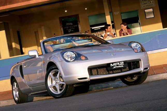 A silver Toyota MR2 Spyder viewed from the front quarter, down low.