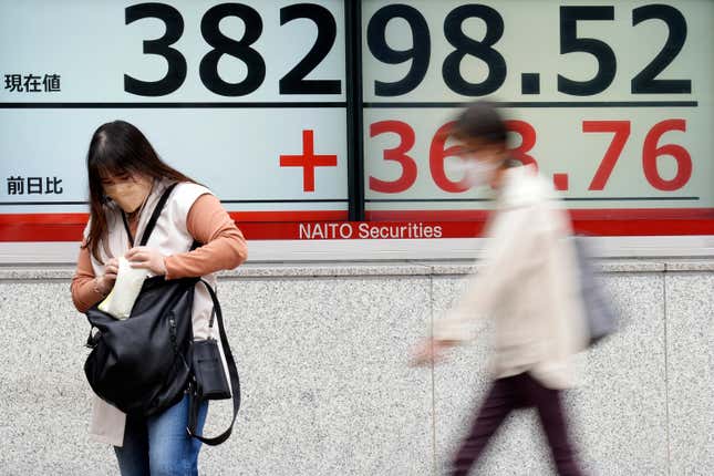 A person stands in front of an electronic stock board showing Japan&#39;s Nikkei 225 index at a securities firm Tuesday, April 30, 2024, in Tokyo. Asian shares mostly rose Tuesday, as investors kept their eyes on potentially market-moving reports expected later this week. (AP Photo/Eugene Hoshiko)