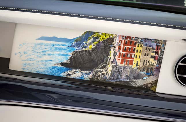 A painting of an Italian village in a Rolls-Royce dashboard