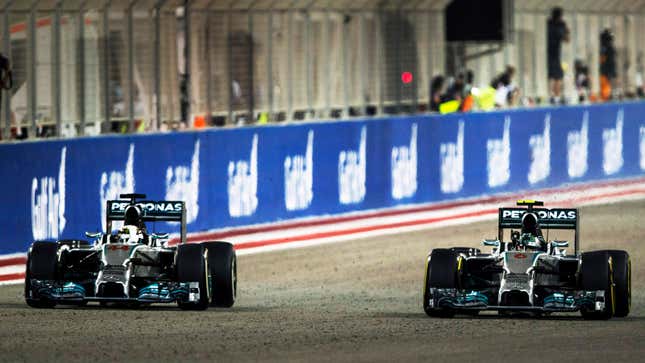 A photo of two Mercedes W05 F1 cars on track. 