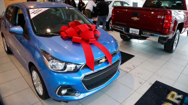 In a photo from Thursday, Dec. 28, 2017, people walk through the Taylor Chevrolet showroom in Taylor, Mich.