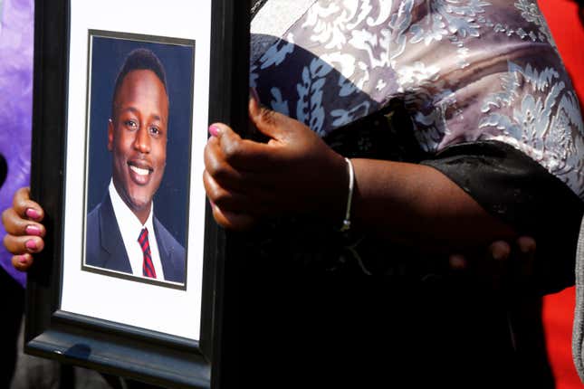 Caroline Ouko, mother of Irvo Otieno, holds a portrait of her son at the Dinwiddie Courthouse in Dinwiddie, Va., on Thursday, March 16, 2023. Speaking at a news conference shortly after watching the video, the family and attorneys condemned the brutal treatment they said Otieno, 28, was subjected to, first at a local jail and then at the state hospital where he died March 6. 