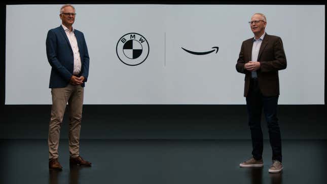 Two boring white guys standing in front of logos.