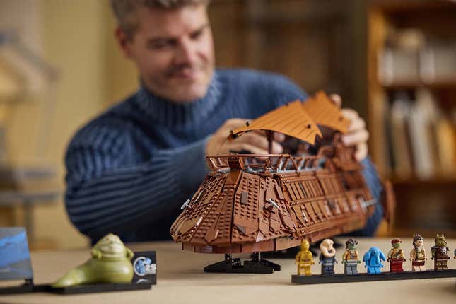 A guy plays with the Lego barge