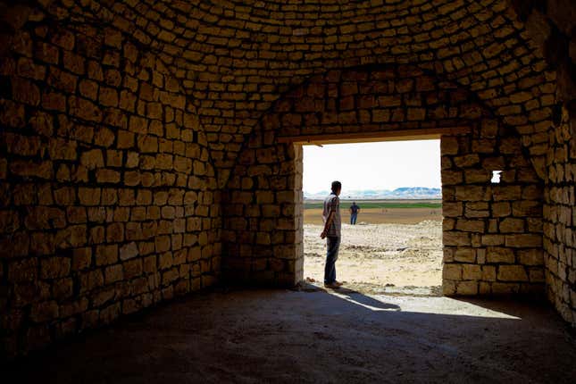 A member of Karm Solar looking out at the farm