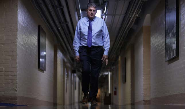 Sen. Joe Manchin walks through a hallway in the basement of the U.S. Capitol.