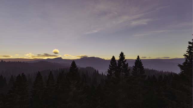 A sun rises over a mountain range. 