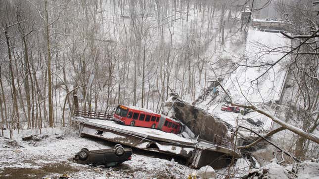 Vehicles including a Port Authority bus are left stranded after a bridge collapsed along Forbes Avenue on January 28, 2022 in Pittsburgh, Pennsylvania. At least 10 people were reportedly injured in the early-morning collapse, hours ahead of a scheduled visit by President Joe Biden to promote his infrastructure plan.