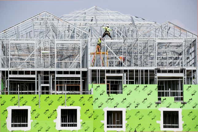 Construction workers build a multi-family complex in Texas.