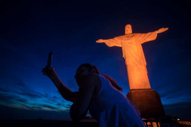 FILE - A tourist takes a selfie with the Christ the Redeemer statue in Rio de Janeiro, Brazil, Nov. 25, 2017. Brazil’s government has postponed until April 2025 tourist visa exemptions for citizens of the U.S., Australia, and Canada that had been scheduled to end on Wednesday, according to a decree published in the nation&#39;s official gazette. (AP Photo/Bruna Prado, File)