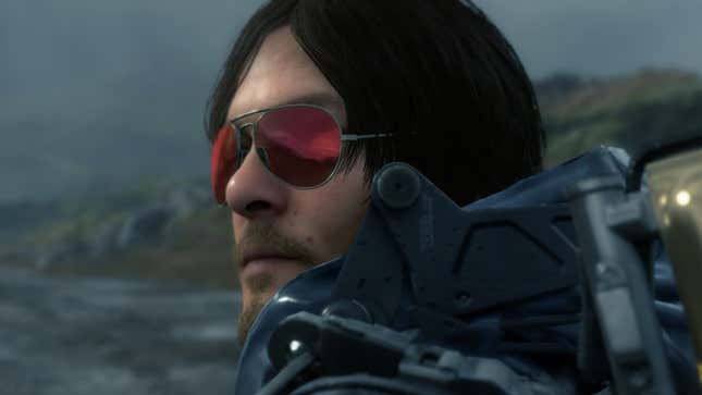 Norman Stranding stares off to the left, through his needless shades, on a gloomy day by the sea.