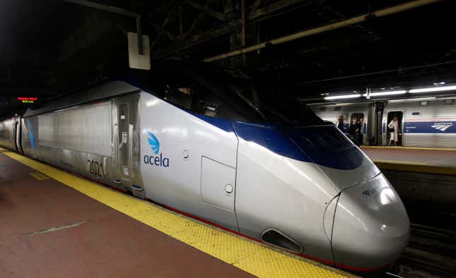 A sleek gray and blue Acela train sits in Penn Station in New York City. 