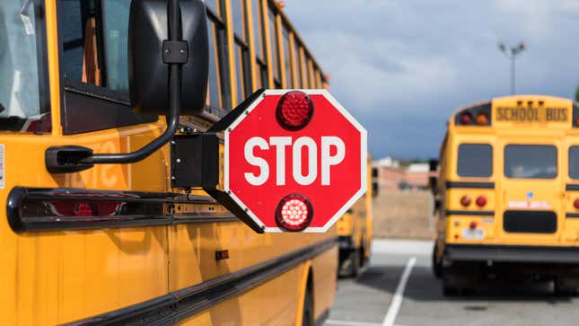 School bus driver checking multiple aspects of the bus before route.