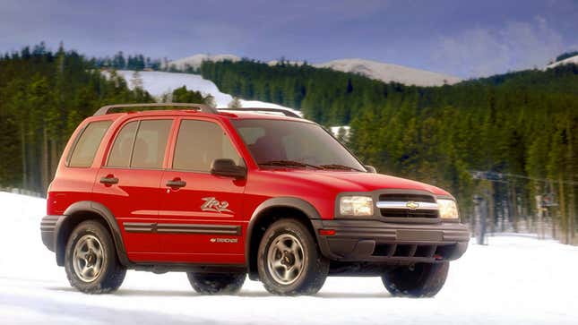 A photo of a red Chevrolet Tracker on snow. 