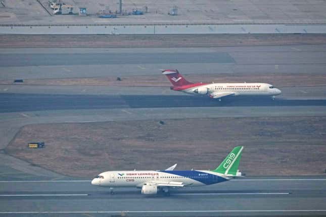 CORRECTS CITY IN IPTC FIELD TO HONG KONG - Chinese-made jets, the C919, front and the ARJ21, back, arrive at the Hong Kong International Airport in Hong Kong, on Tuesday, Dec. 12, 2023. The Chinese C919 commercial passenger jet has arrived in Hong Kong in the Chinese-made aircraft&#39;s first foray outside of mainland China. The C919 plane and another Chinese-made aircraft, an ARJ21, landed Tuesday and will be on display at Hong Kong&#39;s international airport until Sunday. (AP Photo)