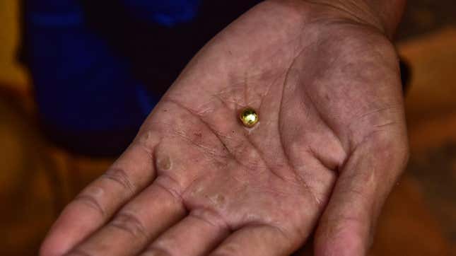 A resident digs and sifts sand to look for gold on March 23, 2017 in Paracale, Philippines. In the mining town of Paracale, about 350 kilometers south of Manila, a day's work of digging and sifting through hundreds of kilos of sand and clay, an artisanal miner can gather about a quarter of a gram of gold dust, enough to earn $5, enough for a family to go through the day's needs. For decades, local residents at Paracale town work in hazardous conditions scavenging under the earth and diving into tunnels filled with mud using only makeshift tools to mine for gold, often placing their health and lives at risk. Ban Toxics, a local NGO working at these sites claims that artisanal mining is a poverty driven industry and that small-scale miners typically work in harsh conditions with no proper training, protection, and pollution control methods. Local reports indicated the country produced about 18 tons of gold at a market value of over $700 million in 2014 while 80% of the gold comes from artisanal and small-scale mines which operate without a government license. The Philippines holds the largest copper-gold deposit in the world and is the fifth most mineral-rich country for gold, nickel, copper, and chromite, but massive environmental destruction prompted the new Department of Environment and Natural Resources secretary, Gina Lopez, to threaten many large-scale mining operations for closure.