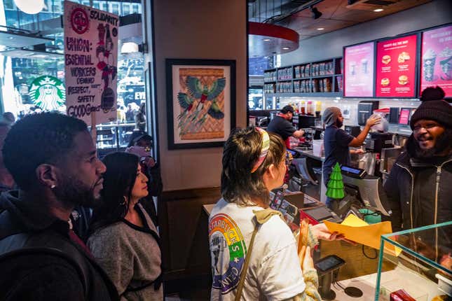 New York Public Advocate Jumaane Williams, far left, and N.Y. State Senator Jessica Ramos, second from left, join union activist Riley Fell, center, who unsuccessfully tries to deliver a petition at a Starbucks store calling for &quot;fair schedule and wages&quot; for its workers, as protestors gathered outside at a rally, Thursday, Nov. 16, 2023, in New York. (AP Photo/Bebeto Matthews)