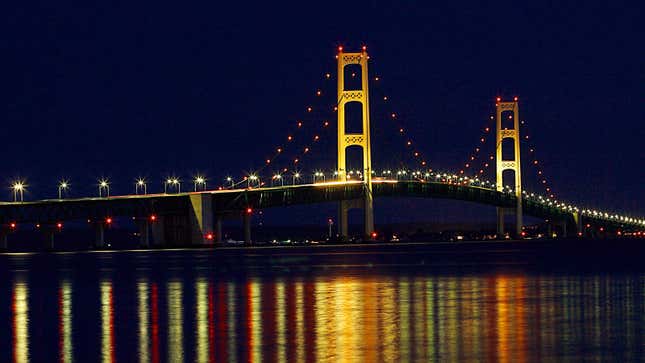 A photo of the Mackinaw suspension bridge illuminated with yellow light. 