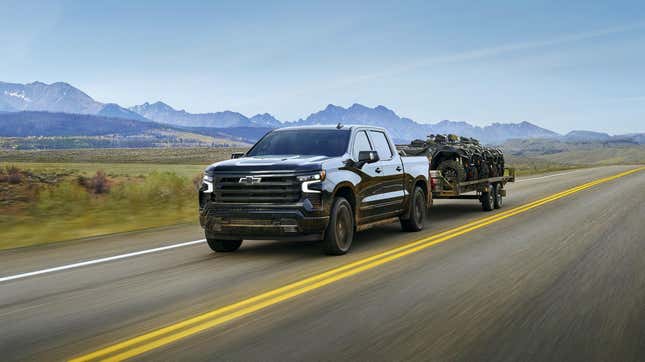 A Chevrolet Silverado towing all-terrain vehicles